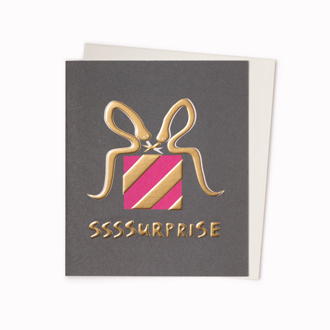 SSSSurprise Greeting Card is a wrapped up parcel with gold ribbon inspired celebratory card featuring artwork by artist and screen printer, David Newton.