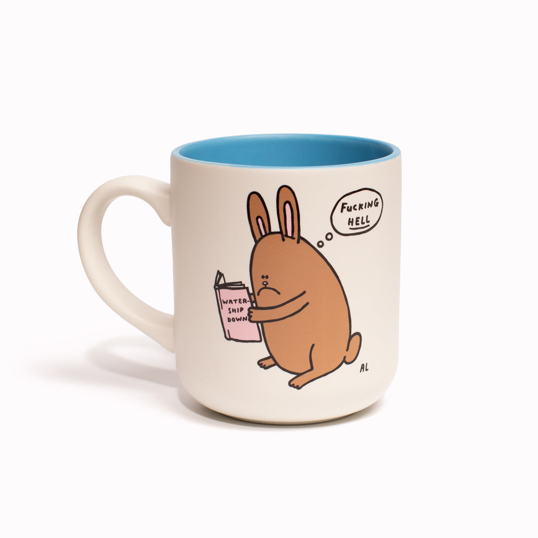 With iconic artwork by the crazy funny Al Murphy, the 'Watership Downer' stoneware mug features a sad faced bunny rabbit thinking an expletive, whilst reading a copy of the classic animal themed novel 'Watership Down' by Richard Adams. Dark wry humour from Al Murphy, illustrated in his comedic art style.&nbsp;